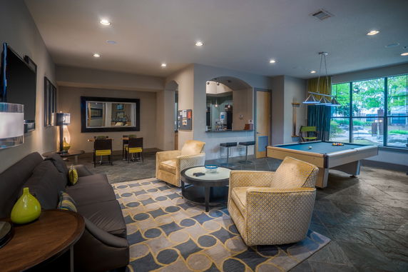 Indoor recreation area with seating and a pool table.