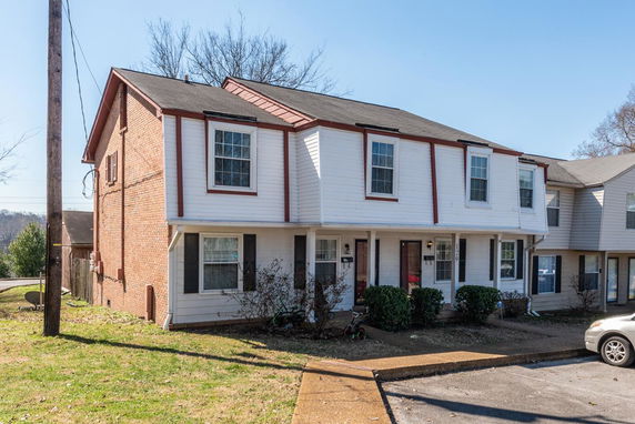 Front view of a two-story house with brick and siding exterior.